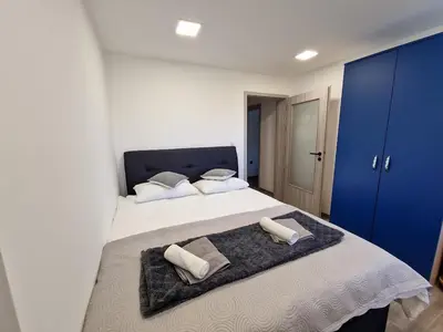 a bedroom with a large bed with two towels on it at POD OREHI - Hiša na podeželju - RAZPRŠENI HOTEL Jeruzalem Slovenija in Miklavž pri Ormožu