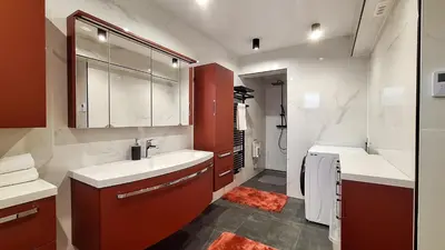 a bathroom with two sinks and a red cabinet at POD OREHI - Hiša na podeželju - RAZPRŠENI HOTEL Jeruzalem Slovenija in Miklavž pri Ormožu