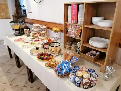 a long table with food and plates on it at Domačija Malnarjevi in Villa Slavina
