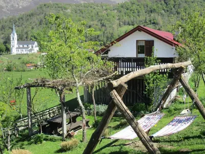 a couple of hammocks in front of a house at Holiday Home Krn&Relax in Kobarid