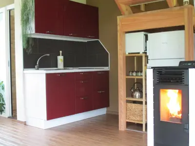 a kitchen with a sink and a stove with a fireplace at Holiday Home Krn&Relax in Kobarid