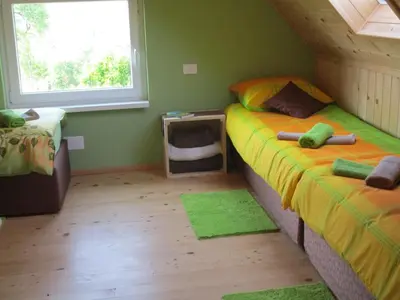 a bedroom with two twin beds and a tv at Holiday Home Krn&Relax in Kobarid