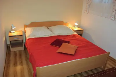 a bedroom with a large bed with two night stands at Apartments Koblar in Kranjska Gora