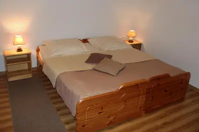 a bedroom with a bed with two lamps on two tables at Apartments Koblar in Kranjska Gora