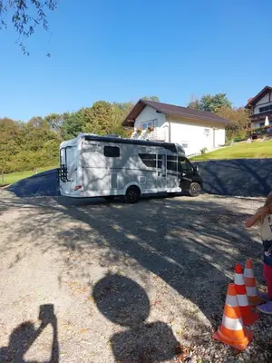 a trailer is parked in a driveway with at Prenočišče ČERNOŠA Apartma Studio in Gradišče v Slovenskih Goricah