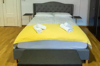 a bed with two towels on top of it at Studio MAYA in Maribor