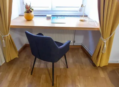 a desk with a chair and a laptop on it at Studio MAYA in Maribor