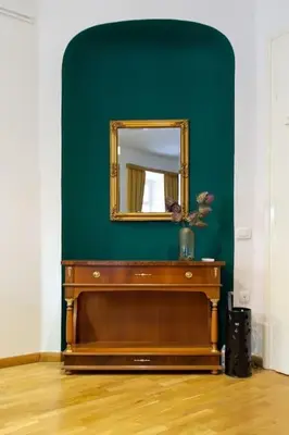 a mirror on top of a wooden dresser in a room at Studio MAYA in Maribor