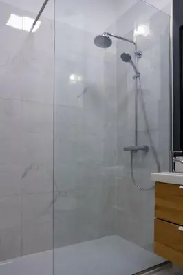 a bathroom with a shower with a glass door at Studio MAYA in Maribor