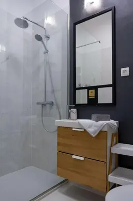 a bathroom with a shower and a sink and a mirror at Studio MAYA in Maribor