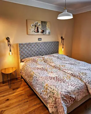 a bedroom with a bed and a table in it at Vila Trate in Križevci pri Ljutomeru