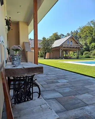 a patio with a table and a house at Vila Trate in Križevci pri Ljutomeru