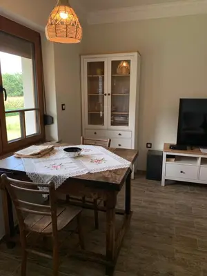 a dining room with a table and a television at Vila Trate in Križevci pri Ljutomeru