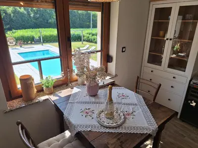 a dining room table with a vase on top of it at Vila Trate in Križevci pri Ljutomeru