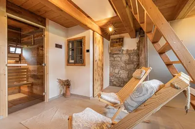a room with a staircase and a rocking chair at House Mimi in Metlika