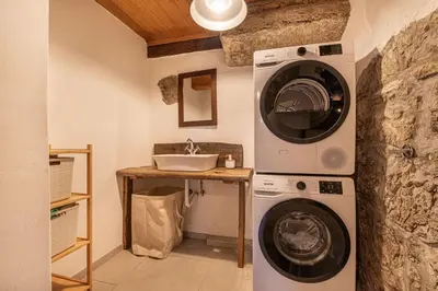 a bathroom with a washing machine and a sink at House Mimi in Metlika