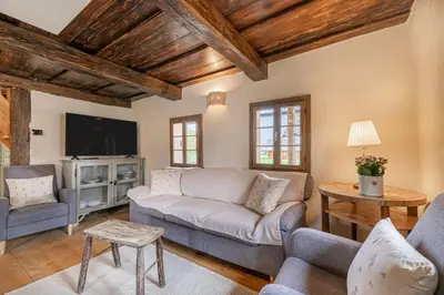 a living room with a couch and a tv at House Mimi in Metlika