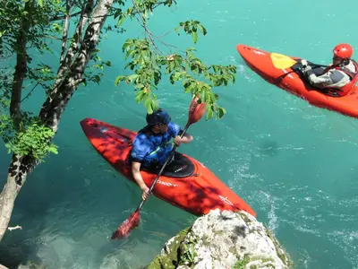 two people are in kayaks in the water at Apartment Mars in Bovec