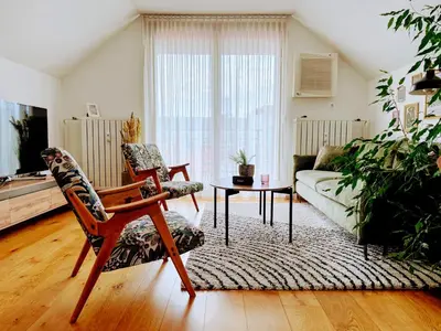 a living room with a couch and a table at Panoramic LOFT in the CityCenter in Maribor