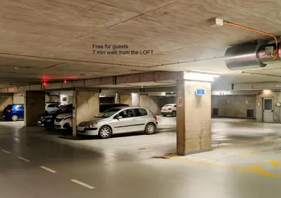 a parking lot with cars parked in a parking garage at Panoramic LOFT in the CityCenter in Maribor