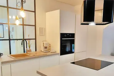 a white kitchen with a sink and a microwave at Panoramic LOFT in the CityCenter in Maribor