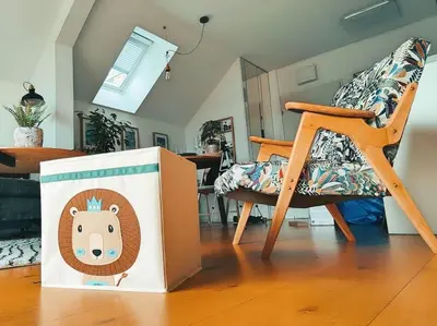 a box with a bear on it next to a chair at Panoramic LOFT in the CityCenter in Maribor