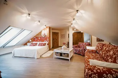a living room with a bed and a couch at Csárdás Salaš in Dobrovnik
