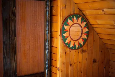 a mirror on the side of a wooden wall at Panorama in Bohinj