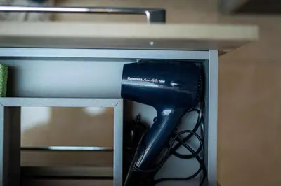 a black hairdryer sitting inside of a table at Panorama in Bohinj
