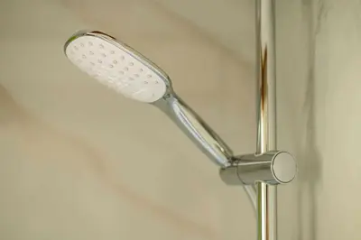 a shower head is attached to a wall at Panorama in Bohinj