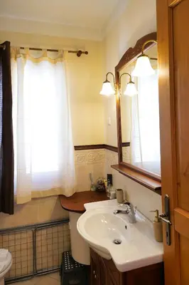 a bathroom with a sink and a mirror at Apartments Vršič with beautiful views on the Mountains with free parking in Kranjska Gora