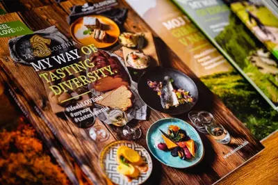 a table topped with plates of food and books at Apartments Luxury AD in Jesenice
