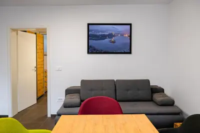 a living room with a couch and a table at Apartments Luxury AD in Jesenice
