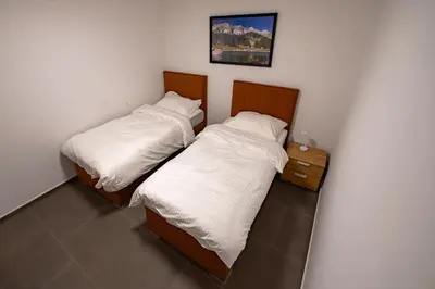 two beds sitting next to each other in a room at Apartments Luxury AD in Jesenice