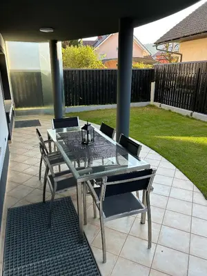 a glass table and chairs on a patio at House Stars in Ljubljana