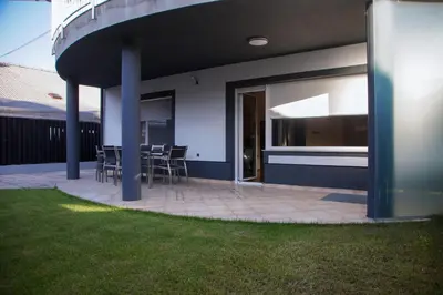 a patio with chairs and tables in a house at House Stars in Ljubljana
