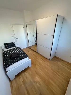 a bedroom with a bed and two mirrors at House Stars in Ljubljana