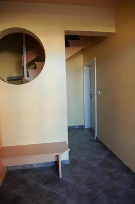 a hallway with a mirror and a bench at House Stars in Ljubljana