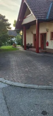 a house with a brick driveway in front of it at Apartma Ob Krki in Straža