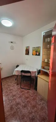 a room with a table in a room with a kitchen at Apartma Ob Krki in Straža