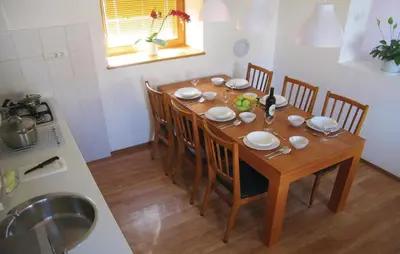 a dining room table with chairs and a kitchen at 3 Bedroom Amazing Home In Tolmin in Tolmin