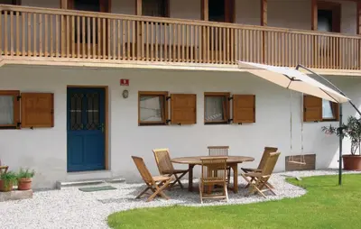a patio with a table and chairs and an umbrella at 3 Bedroom Amazing Home In Tolmin in Tolmin
