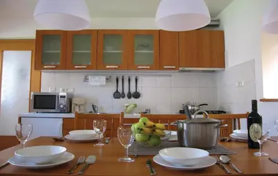 a kitchen with a table with plates and wine glasses at 3 Bedroom Amazing Home In Tolmin in Tolmin