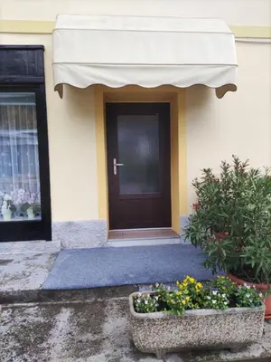 a front door of a house with a cross on the door at Soba Kolovrat in Straža
