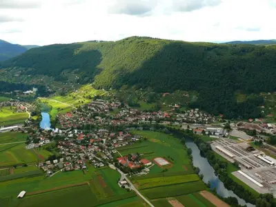 an aerial view of a town next to a river at Soba Kolovrat in Straža