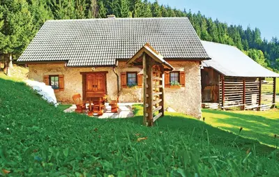 a small house in the middle of a green field at Beautiful Apartment In Mozirje in Mozirje
