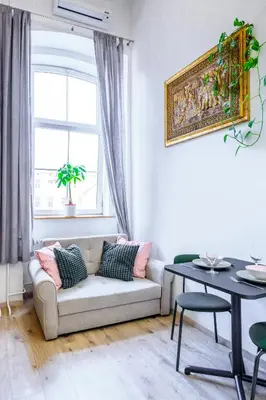 a living room with a couch and a table at The Lovely Loft in Ljubljana