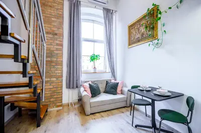 a living room with a couch and a table at The Lovely Loft in Ljubljana