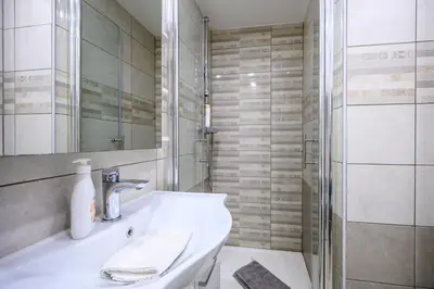 a bathroom with a sink and a shower at The Lovely Loft in Ljubljana