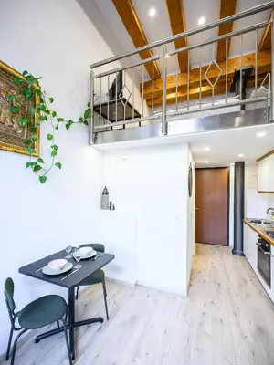a kitchen and dining room with a table and chairs at The Lovely Loft in Ljubljana